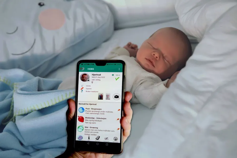 En baby som sover med en mobiltelefon