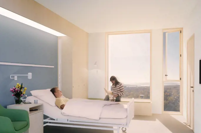 Bildet viser et rom på sykehus. En pasient ligger i sengen.