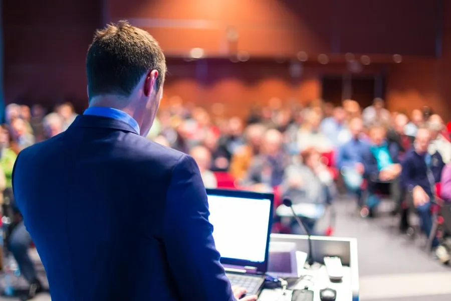 speaking at a conference, illustration photo by Shutterstock