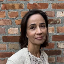 Woman in front of a brick wall